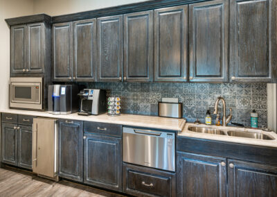 A renovated breakroom kitchen in OKC at an office building done by the commercial building contractors at Hill Construction.