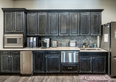 An office kitchen at a commercial building that was renovated back to its original luster by Hill Construction Solutions.